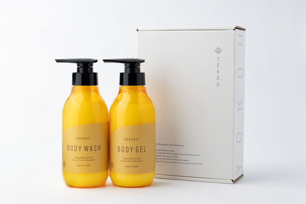 Two yellow pump bottles labeled "Body Wash" and "Body Gel" (BERGAMOT GOLD) next to a white box.