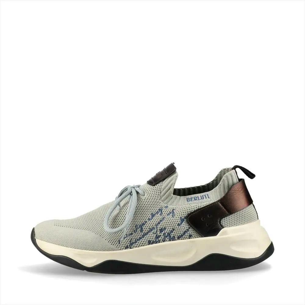 Side view of a gray and brown Berluti leather and fabric men's sneaker with calligraphic embroidery and a white sole.
