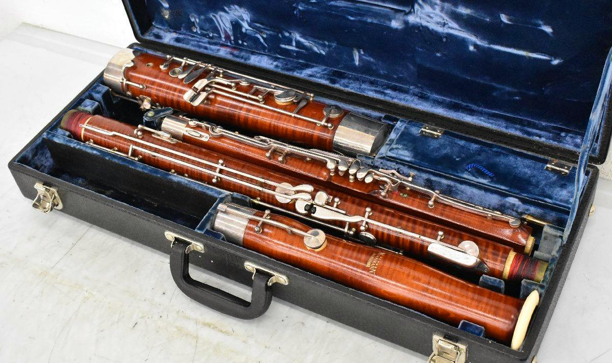 Disassembled wooden bassoon (fagott) with metal keywork shown inside an open blue-velvet lined carrying case.