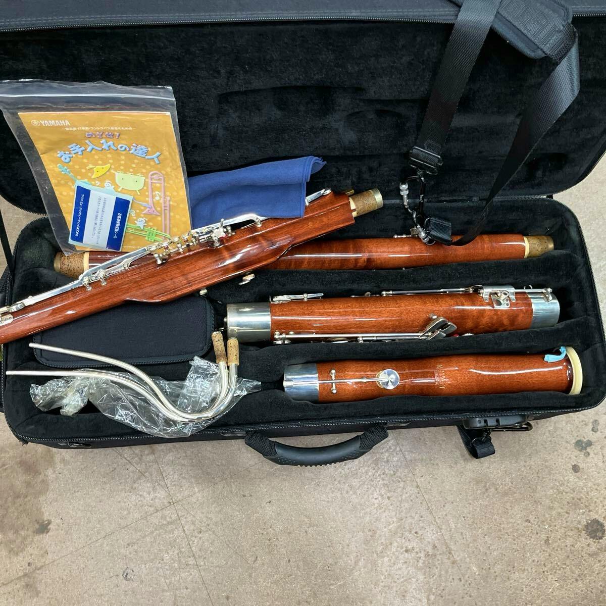 Disassembled bassoon (fagott) and its joints, bocals, and accessories arranged inside an open carrying case.