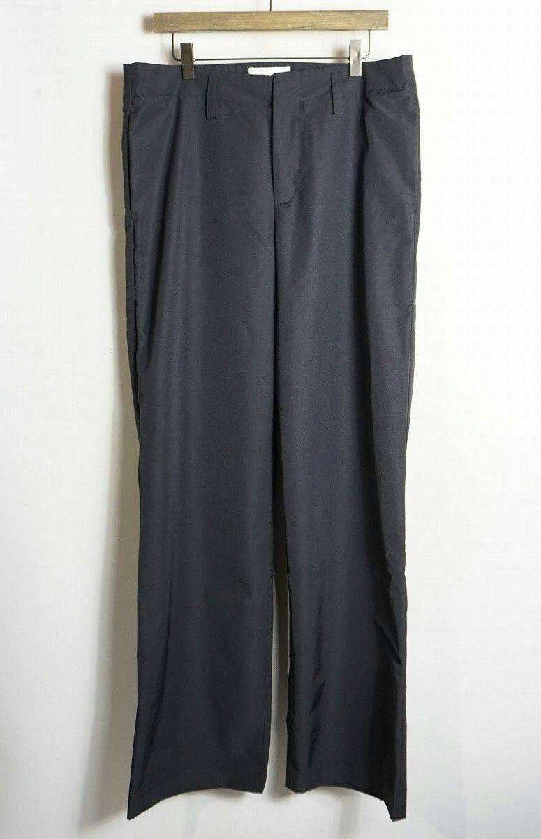 Black Loro sargeant straight slacks (pants) hanging on a wooden hanger against a white background.