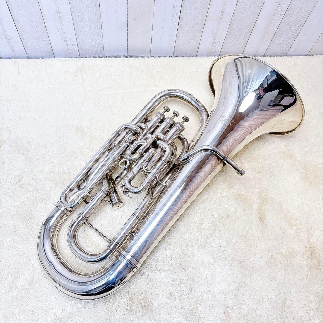 Silver BESSON SOVEREIGN 968 euphonium placed on a light surface showing its valves and bell.