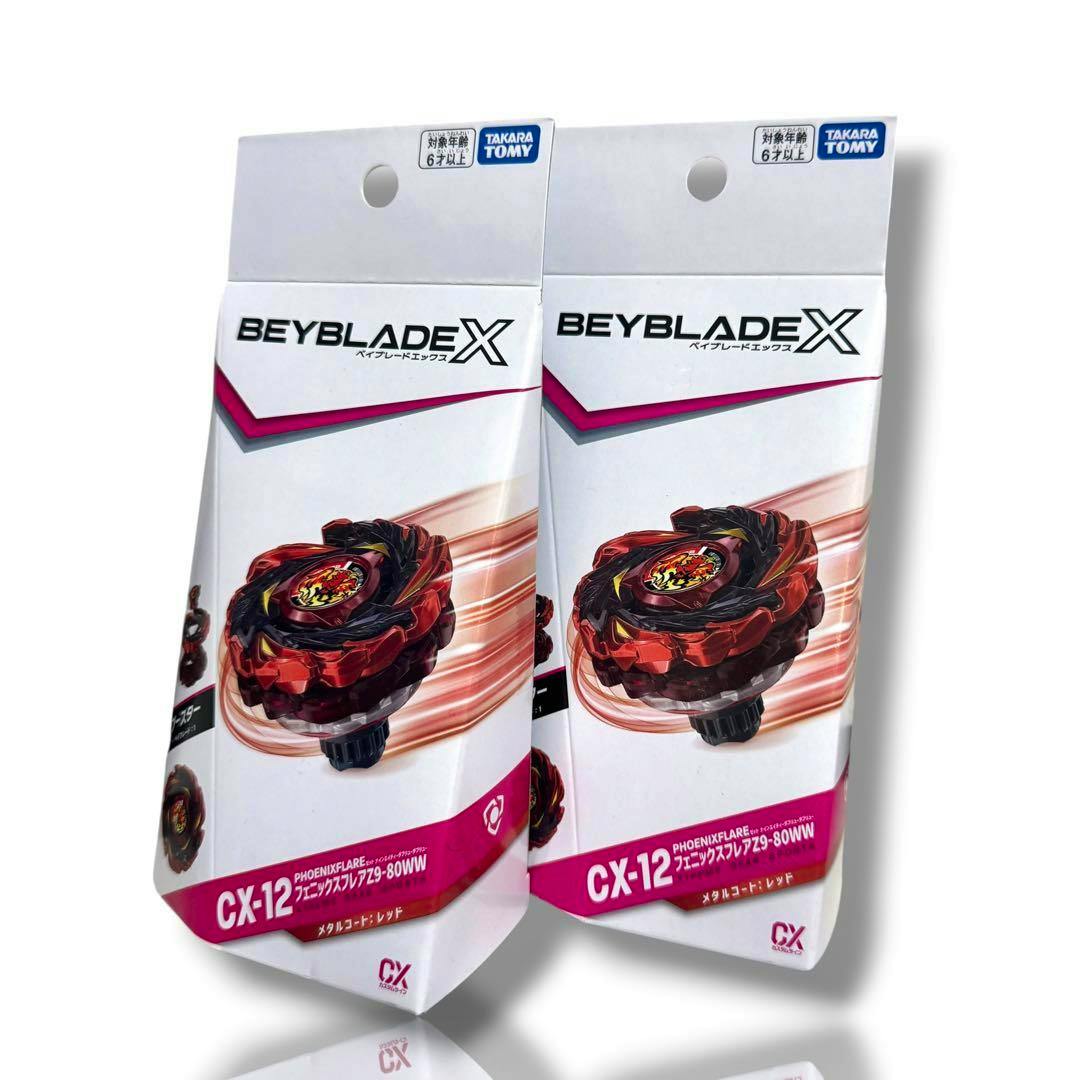 Front view of two unopened Beyblade X CX-12 Phoenix Flare product boxes showing the packaging artwork.