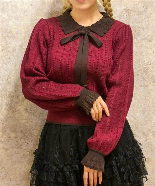 Model wearing a bicolor collared knit pullover sweater in red with dark brown collar and cuffs.