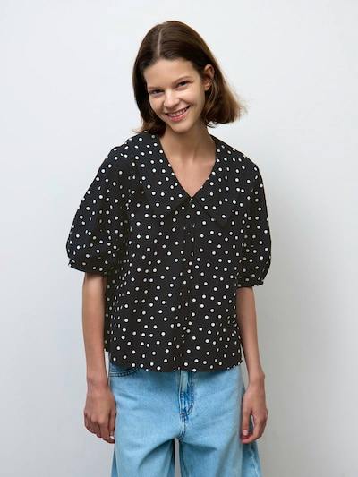 Model wearing a black polka-dot big-collar blouse (5分袖) paired with light blue jeans.