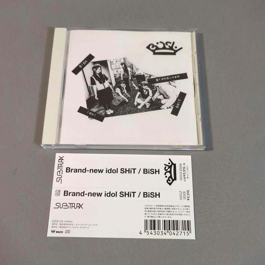 Front cover of the CD "Brand-new idol SHiT" by BiSH showing the jewel case with a black-and-white band photo and an obi strip beneath.