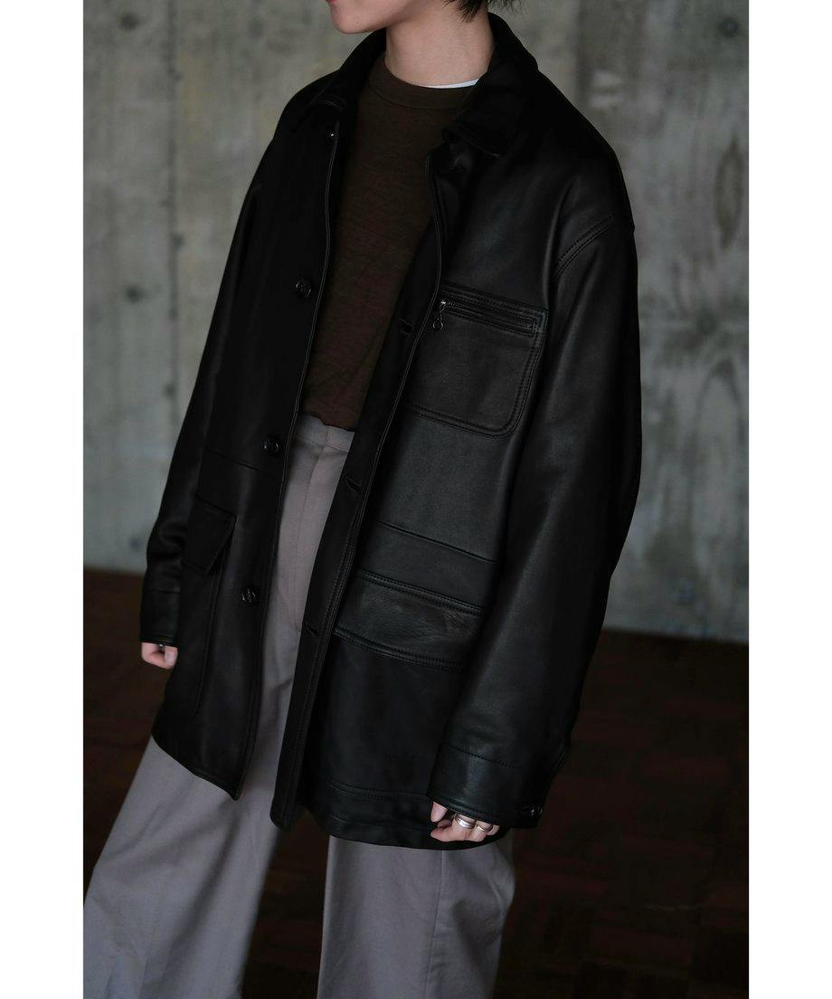 Model wearing the black BISOWN LUMB leather hunting jacket, front view showing pockets and buttons.
