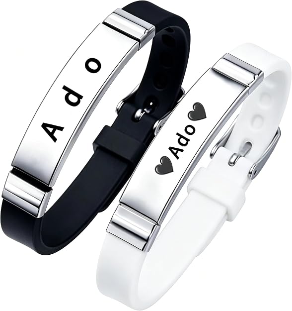 Two silicone wristband bracelets, one black and one white, each with a stainless steel plate engraved "Ado".