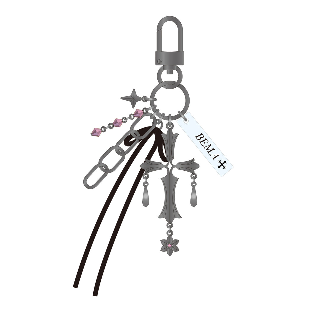 Illustrated keychain charm showing metal cross-shaped pendants, pink bead chain, black leather straps, and a rectangular tag with printed text.