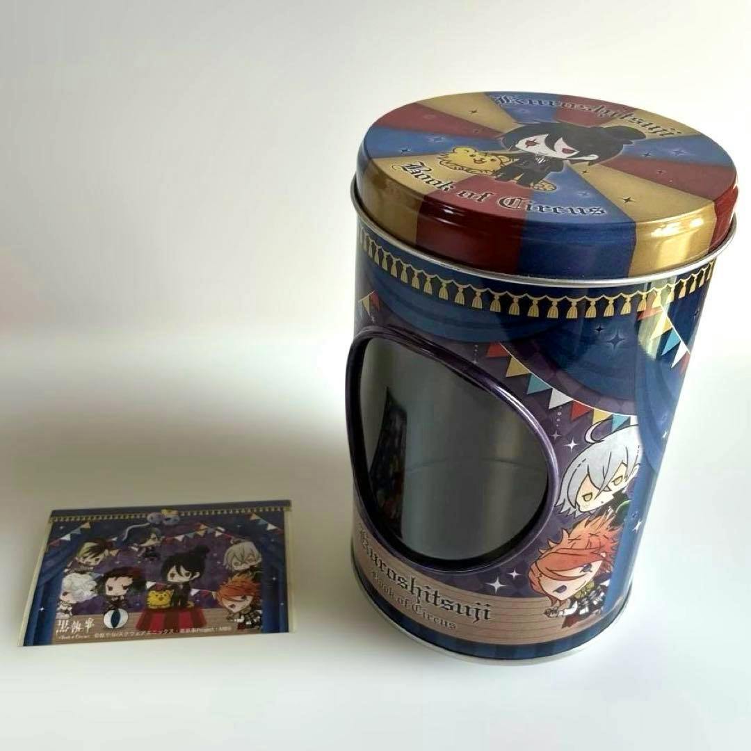 A round Kuroshitsuji Book of Circus decorative tin can with a front window and matching illustrated card shown beside it.