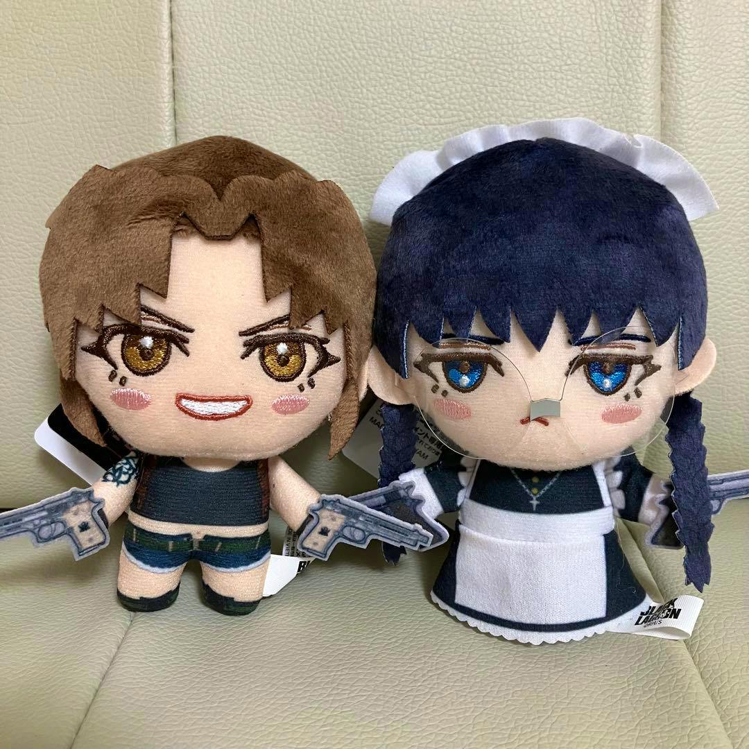 Two BLACK LAGOON plush toys (Revy and Roberta) sitting side by side on a light-colored surface.