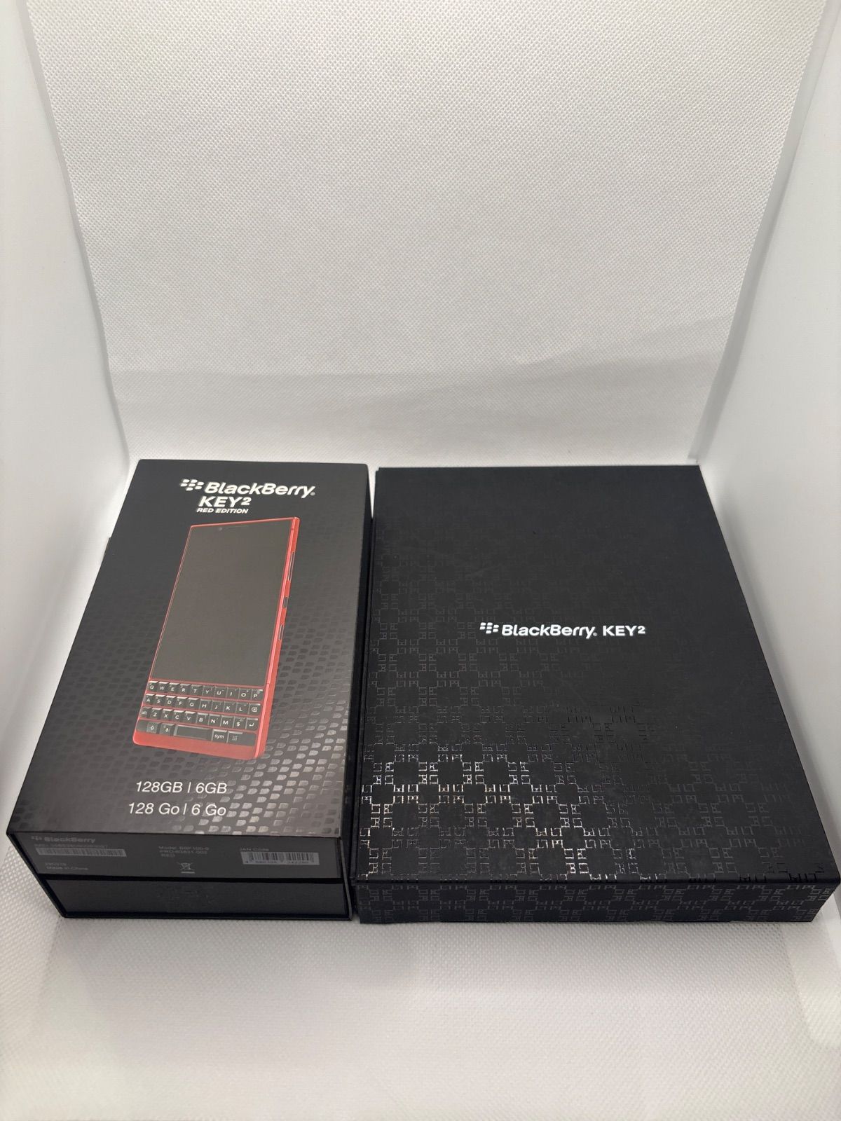 Two BlackBerry KEY2 retail boxes side by side, including the Red Edition box showing the phone image.