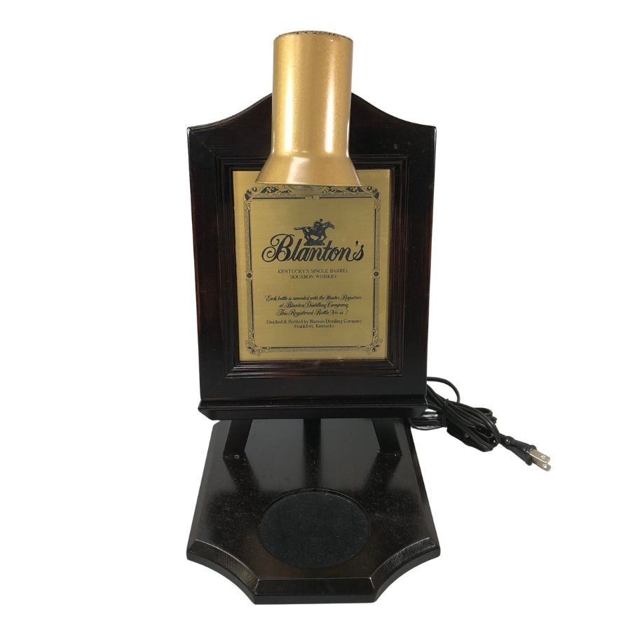 Blanton bottle display LED table lamp on a black stand with a visible power cord.