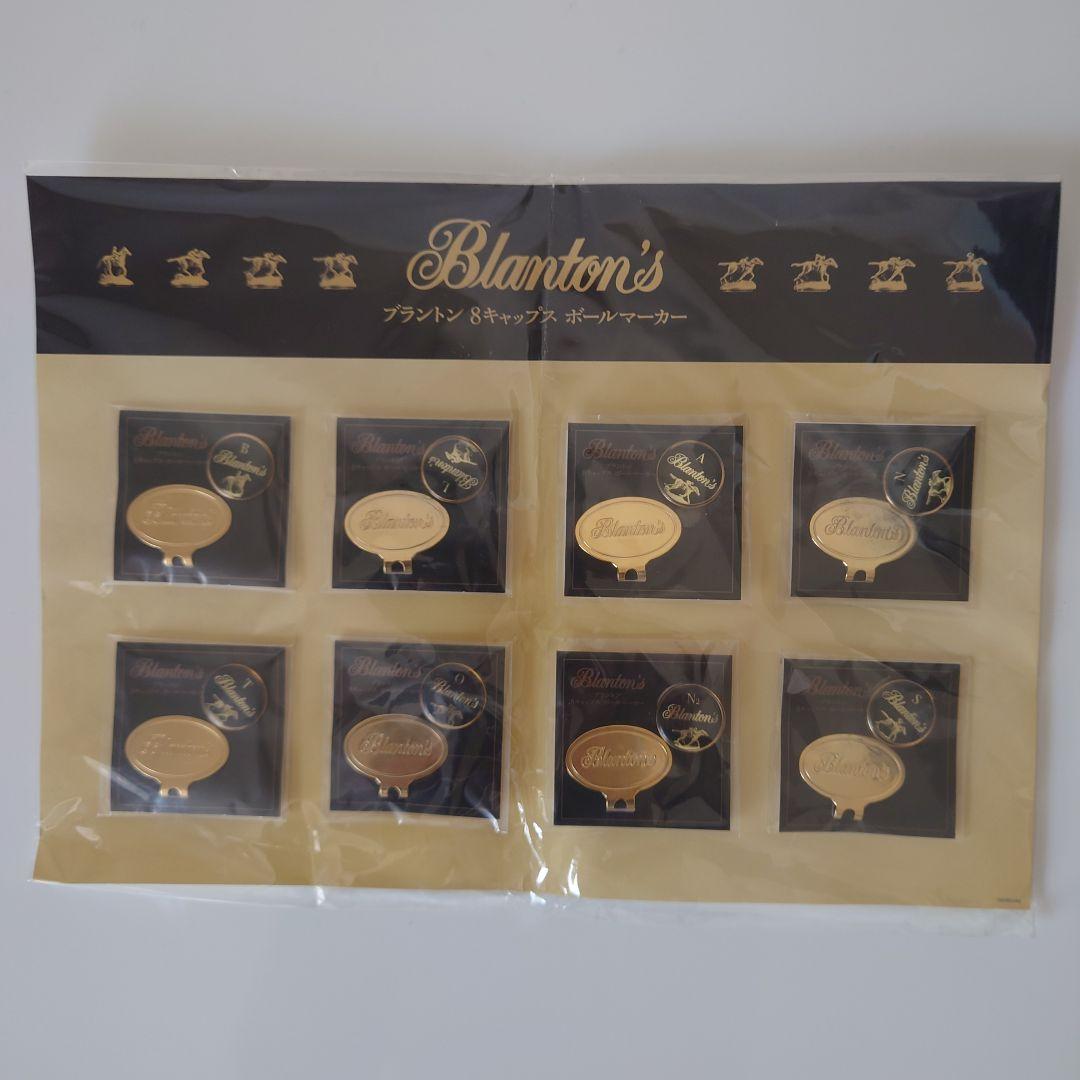 Packaged set of eight Blanton's golf markers arranged in a display card with branded header.