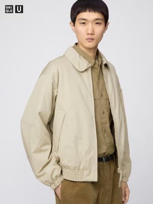 Model wearing a beige BlockTech utility parka shown front view over a shirt.