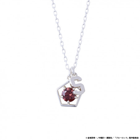 Close-up of the silver Blue Lock Itoishi Sae stone pendant necklace showing a red gem set in a pentagon frame with an 'S' charm on a silver chain.