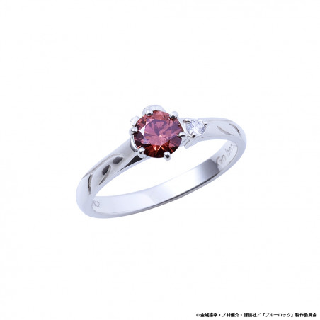 Silver ring with a central pink round gemstone and two small side stones on a white background.