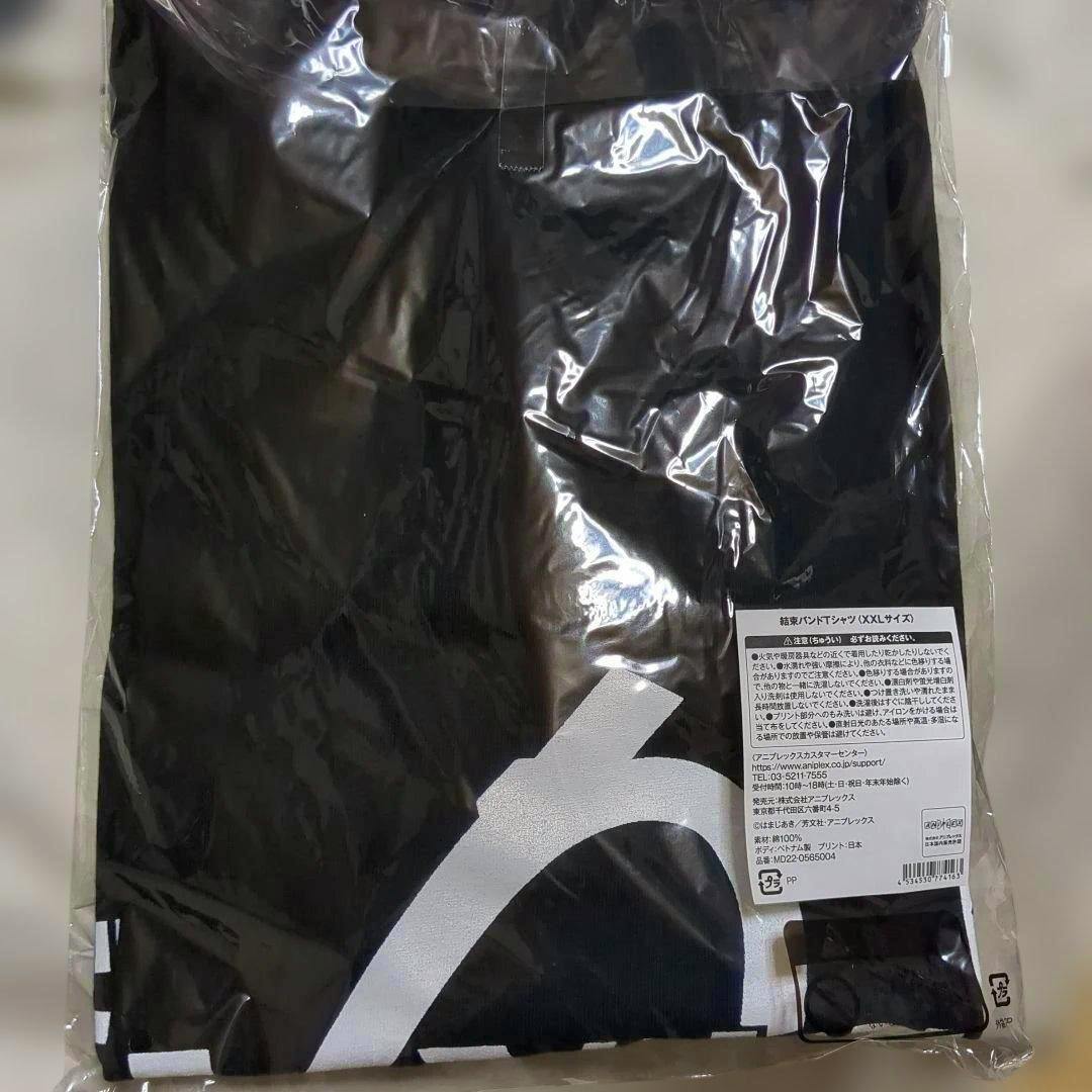 Folded black T-shirt (ぼっち・ざ・ろっく！ 結束バンド) in clear plastic packaging showing a white graphic and a product label.