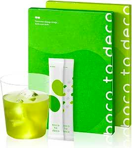 A green product box shown with two white stick sachets and a glass of bright green drink representing the green juice powder.
