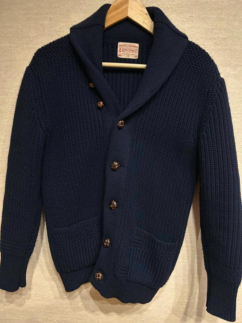 Front view of a navy Boncoura shawl-collar knit cardigan (size 38) hanging on a wooden hanger, showing buttons and front pockets.