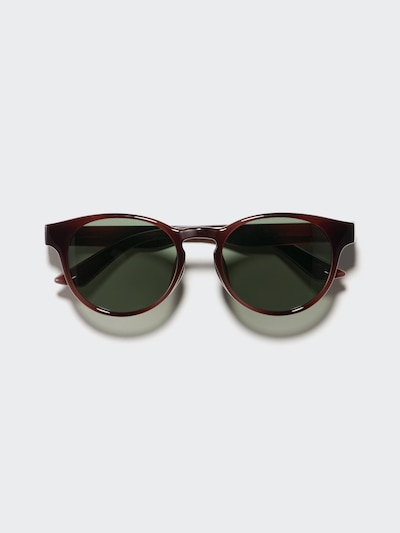 Front view of plastic Boston-style sunglasses with dark red-brown frame and green lenses on a light background.