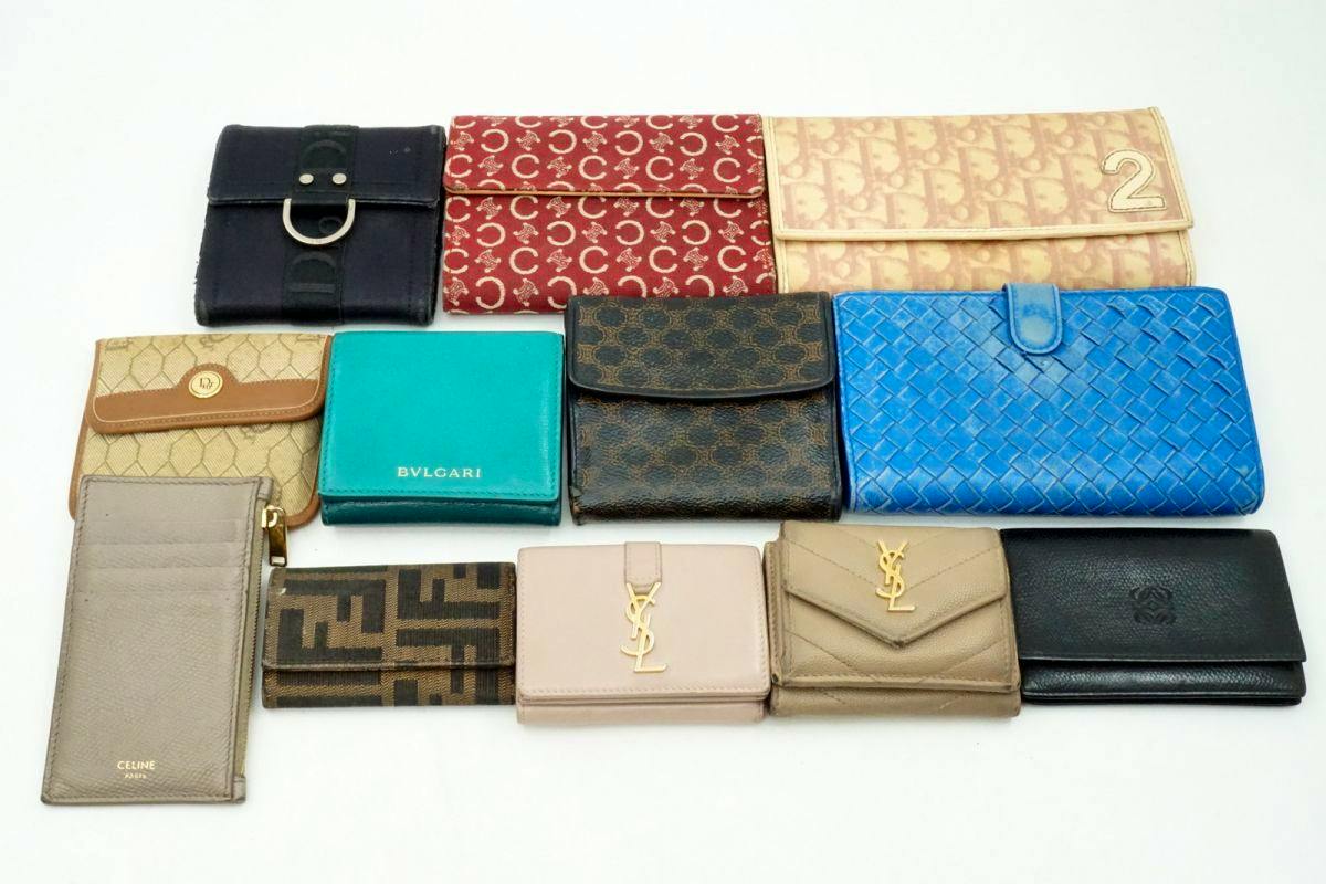 Twelve assorted long wallets, card cases, and key/pass cases arranged on a white background.