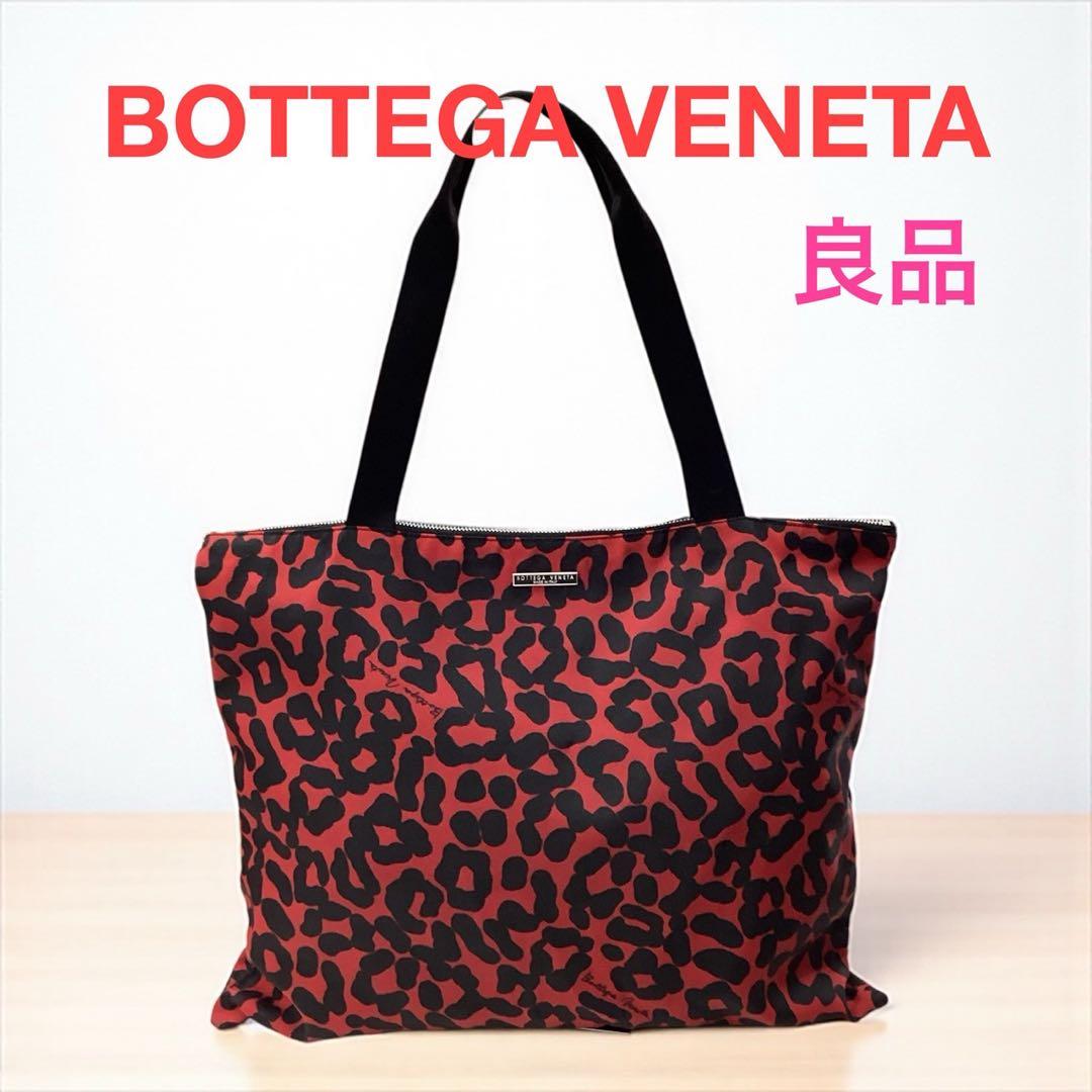 Red leopard-print reusable tote bag with black handles shown against a white background with red "BOTTEGA VENETA" text overlay.