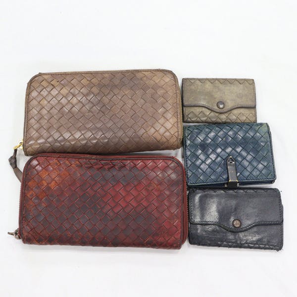 Five BOTTEGA VENETA woven-style wallets in various colors arranged on a white background.