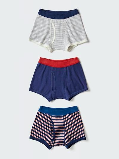 Three boys' cotton boxer briefs with front opening in solid and striped designs laid out vertically on a light background.