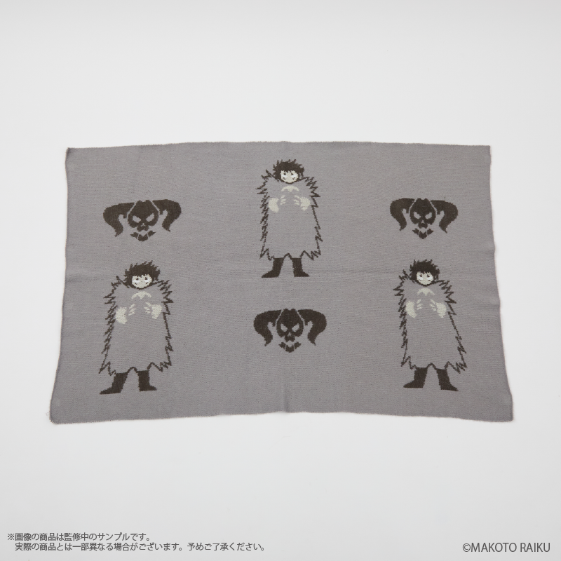 A gray rectangular polyester blanket laid flat showing repeated Brago character and skull motifs.