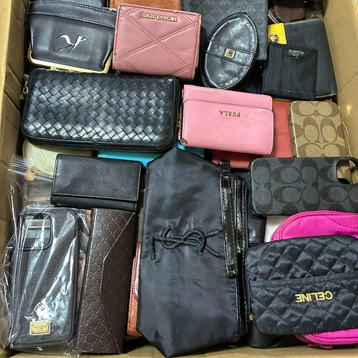 Cardboard box filled with assorted wallets and small leather goods shown as a bulk lot.