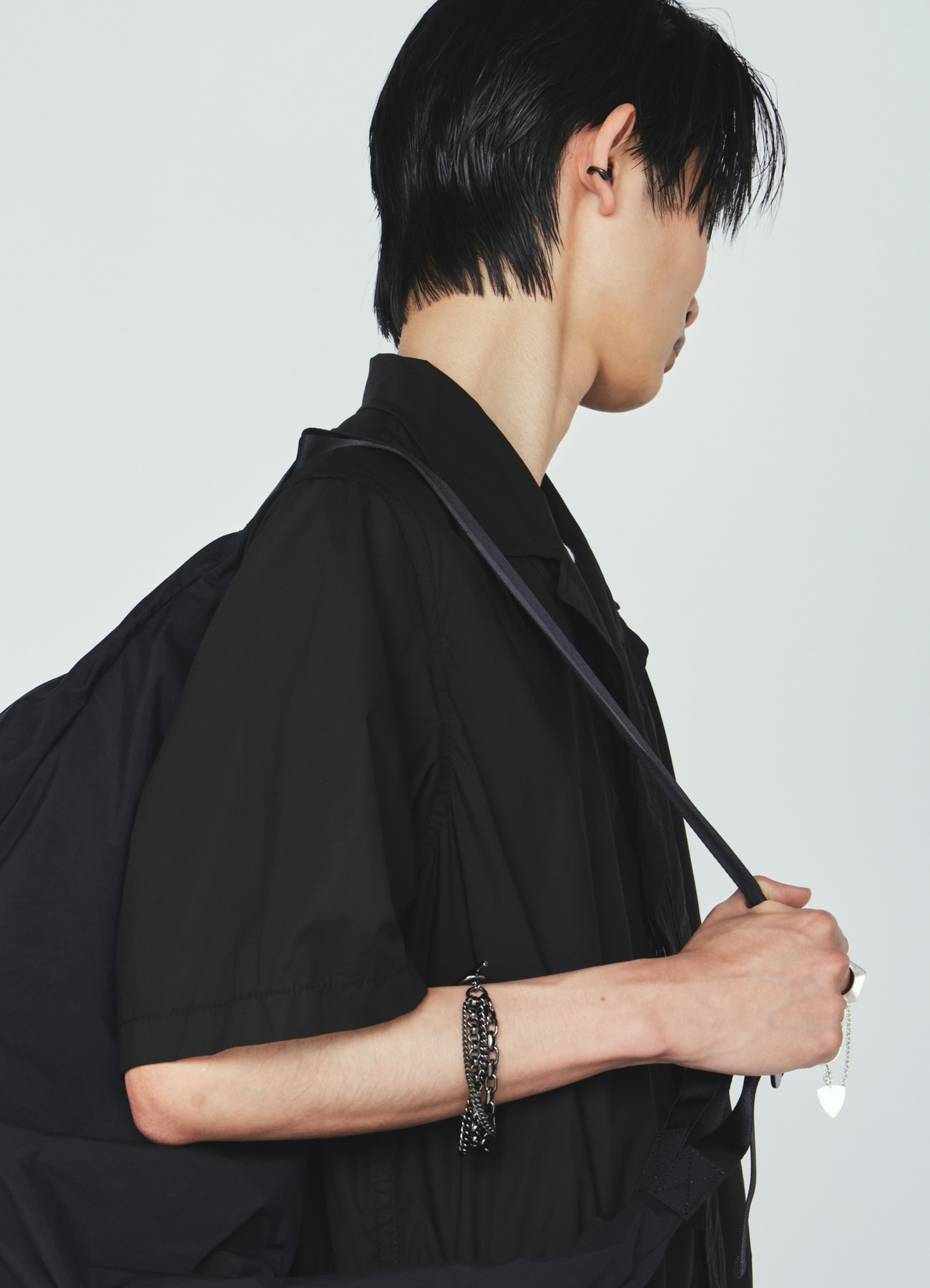 Side view of a model wearing the brass 4-row chain bracelet on their wrist.