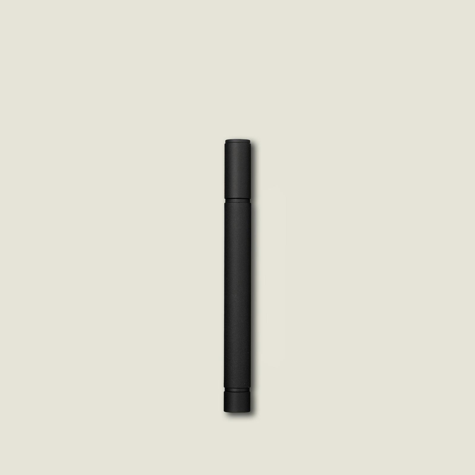 A closed mechanical pencil lead case shown vertically centered on a pale background.