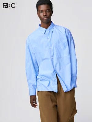 Model wearing a light blue oversized men's shirt.