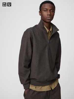 A model wearing the brushed half-zip sweater (front view) layered over a shirt.