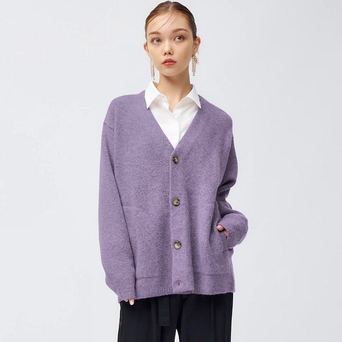 A model wearing a purple long-sleeve brushed yarn cardigan with front buttons over a white shirt.