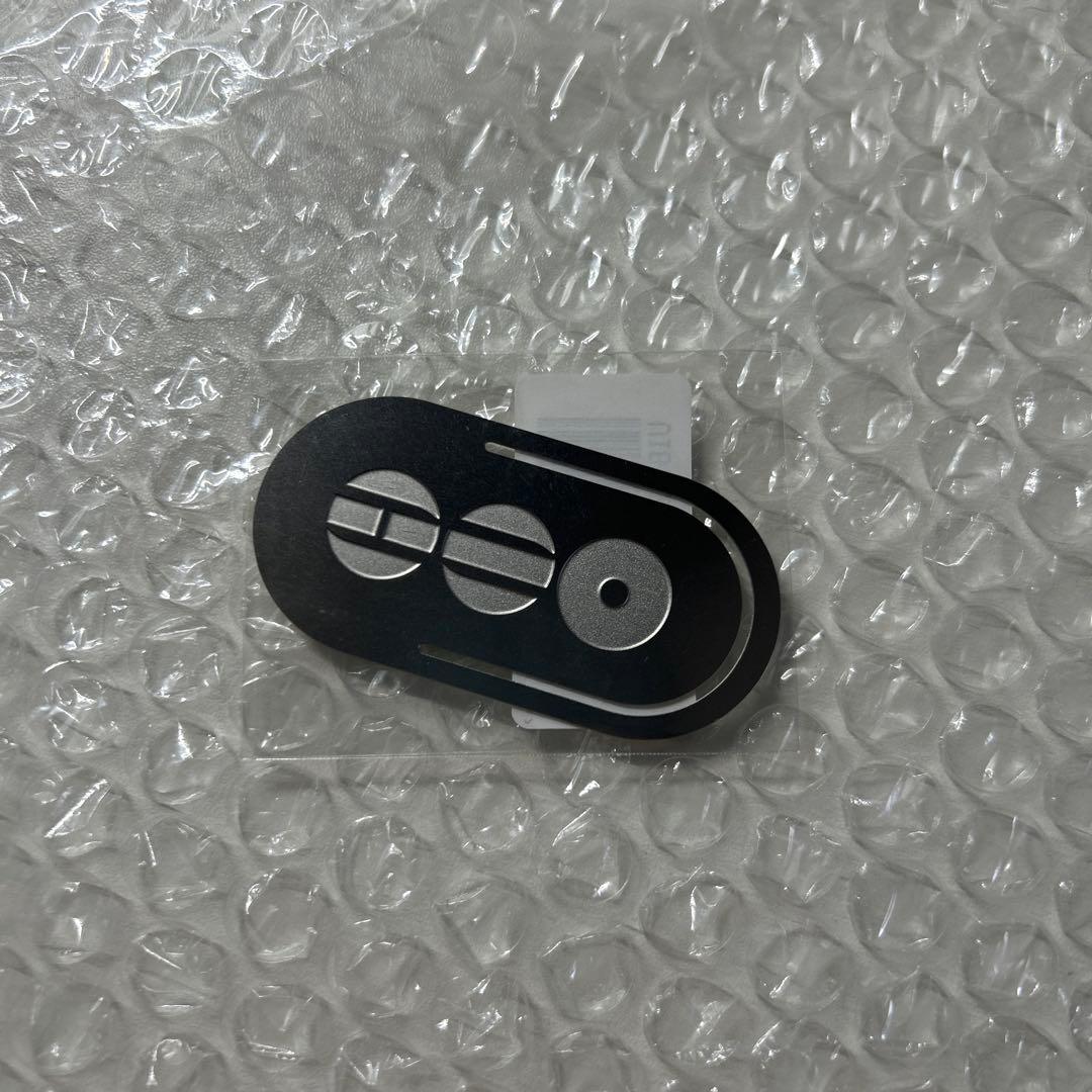 Black metal bookmark clip with silver circular decorations shown on bubble-wrap background.