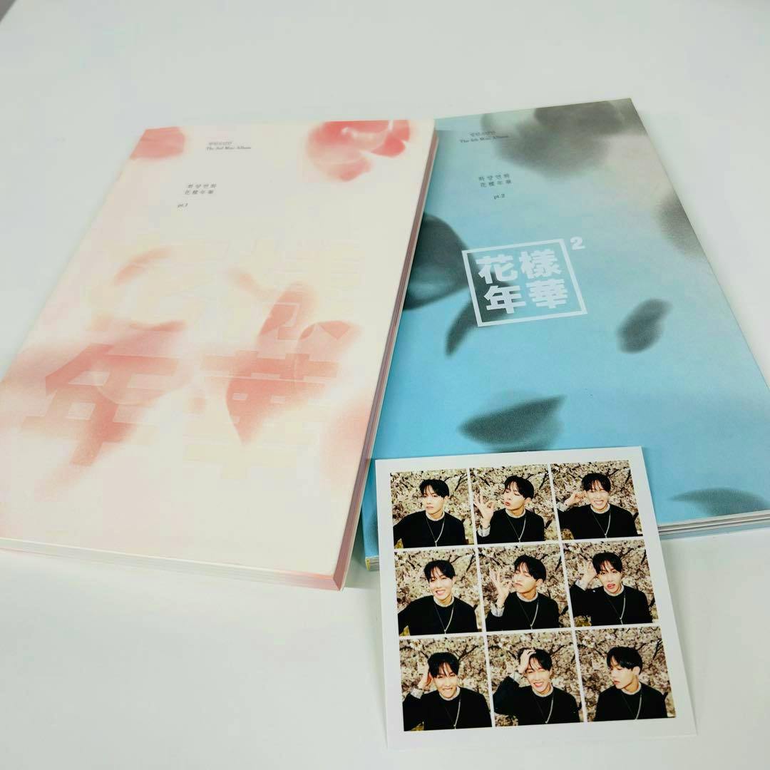 Two BTS 花様年華 pt.1 and pt.2 Korean albums laid flat on a white background with a small photocard sheet of member photos.