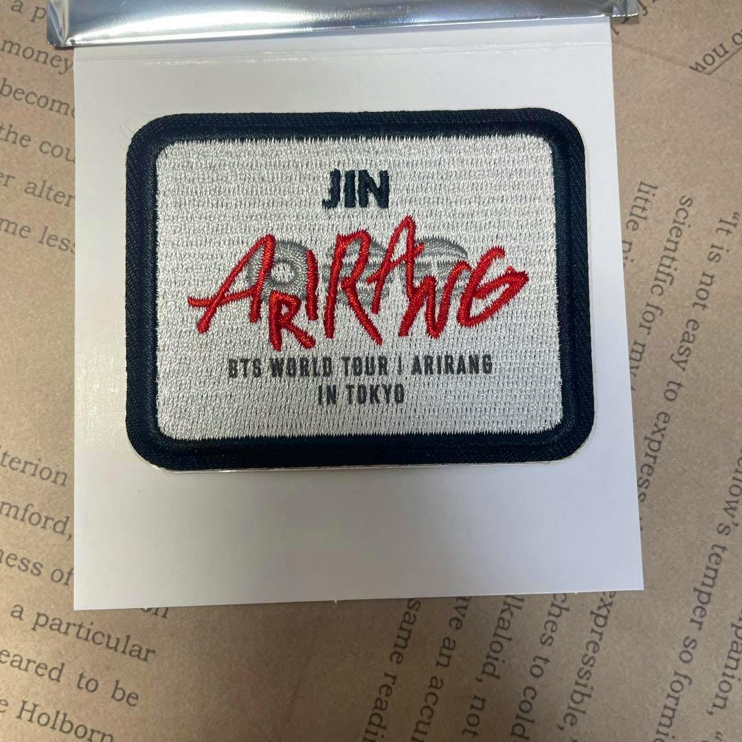 Rectangular embroidered BTS WAPPEN STICKER_TOKYO JIN showing 'JIN' and red 'ARIRANG' text on a white backing.