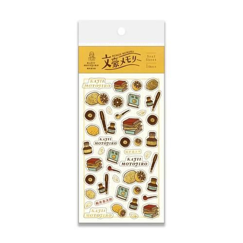 Packaged foil-stamped sticker sheet showing multiple small decorative stickers (books, ink bottles, cups and other icons) under a header card labeled 文豪メモリー.