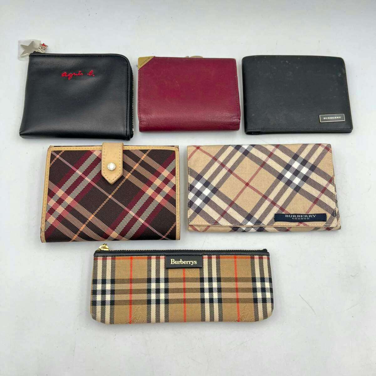 Five wallets and one Burberry pencil case arranged on a white background.