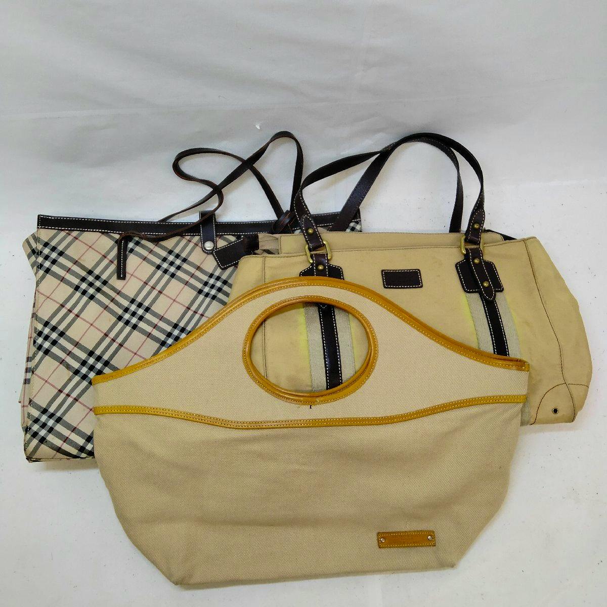 Three canvas bags for a bulk set, including a plaid checked tote and two beige canvas bags laid on a white background.