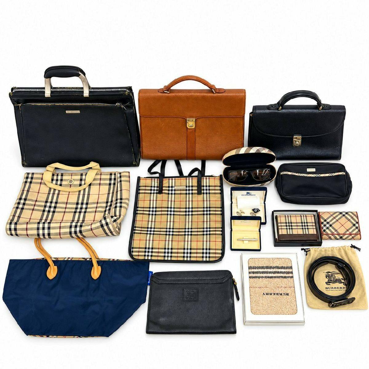 A laid-out assortment of Burberry bags, wallets, and accessories (including checked totes, black and brown handbags, a sunglasses case, and small items) on a white background.