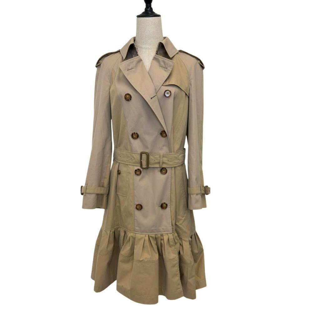 Beige Burberry bicolor frill trench coat displayed on a dress form, front view.