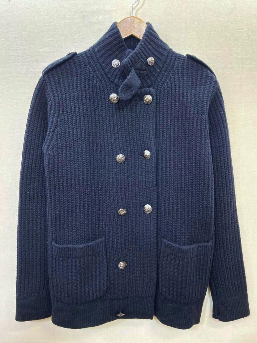 Front view of the black men's wool knit jacket with double-breasted buttons and two front pockets on a hanger.