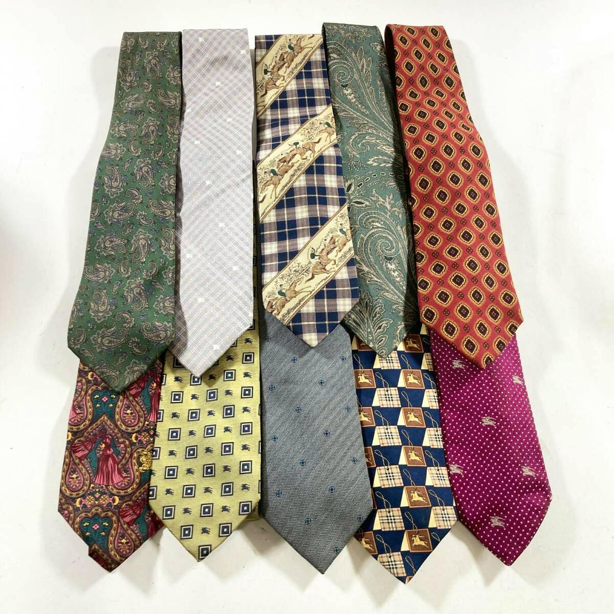 Ten men's silk neckties in various paisley, check, and patterned designs arranged on a white background.