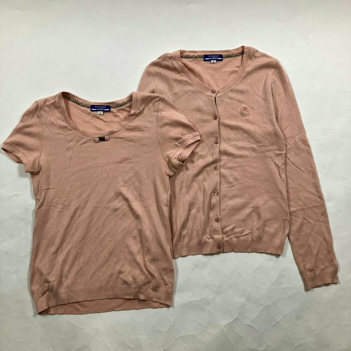 Two salmon-pink Burberry Blue Label cotton tops—a short-sleeve knit and a button-up cardigan—laid flat on a white background.