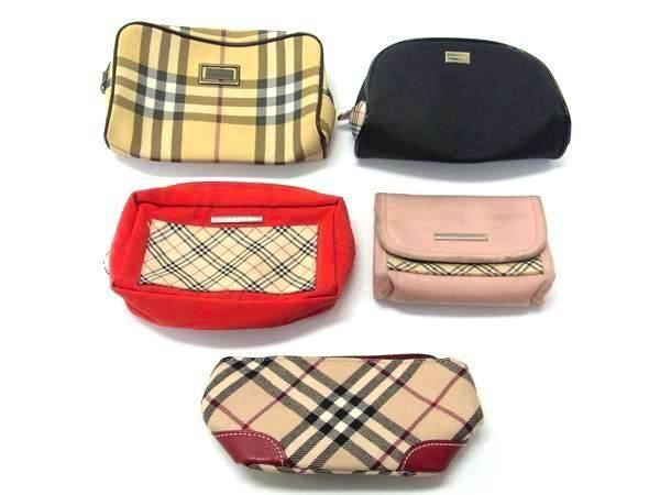 Five Burberry pouches and cases, including Nova check patterns, arranged on a white background.