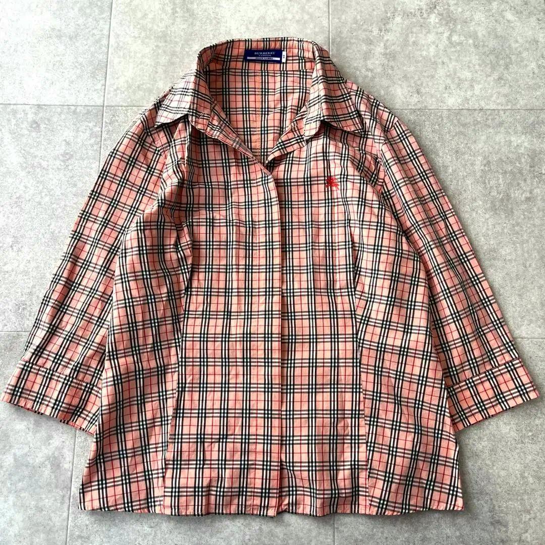 Pink Burberry Blue Label nova-check men's cotton shirt laid flat on a tiled surface.