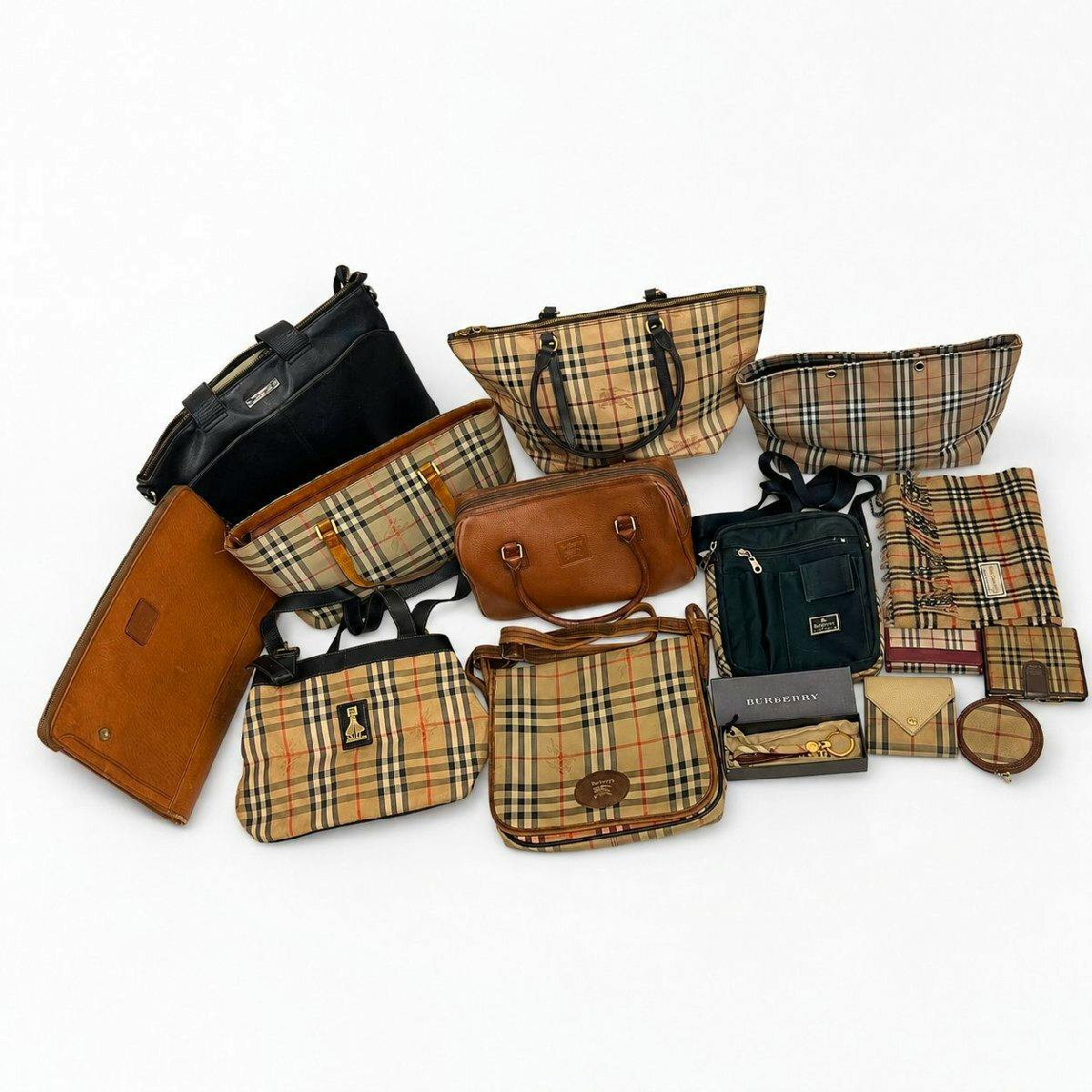 Multiple Burberry bags and accessories in Nova check and brown leather arranged on a white background.